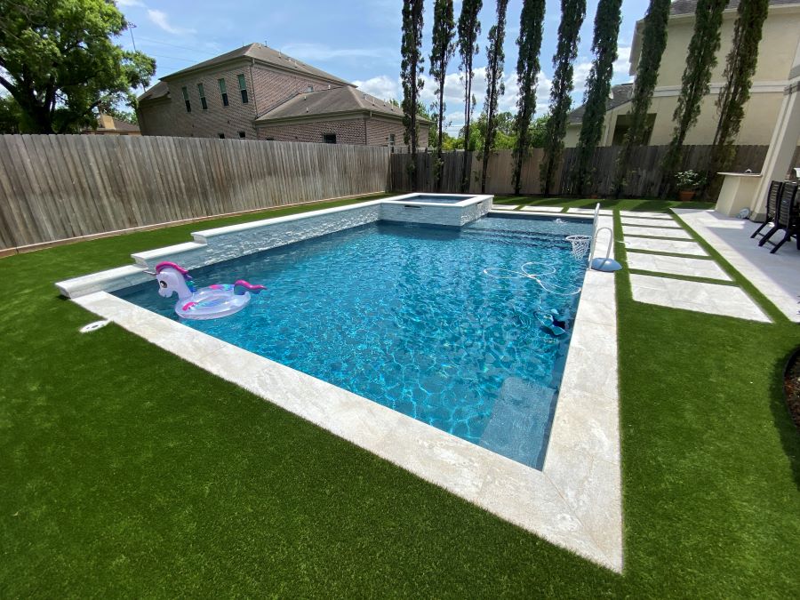 Backyard pool with inflatable unicorn float.